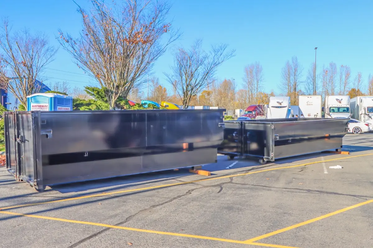 Professional dumpster rental service with roll-off container on residential driveway in Bright
